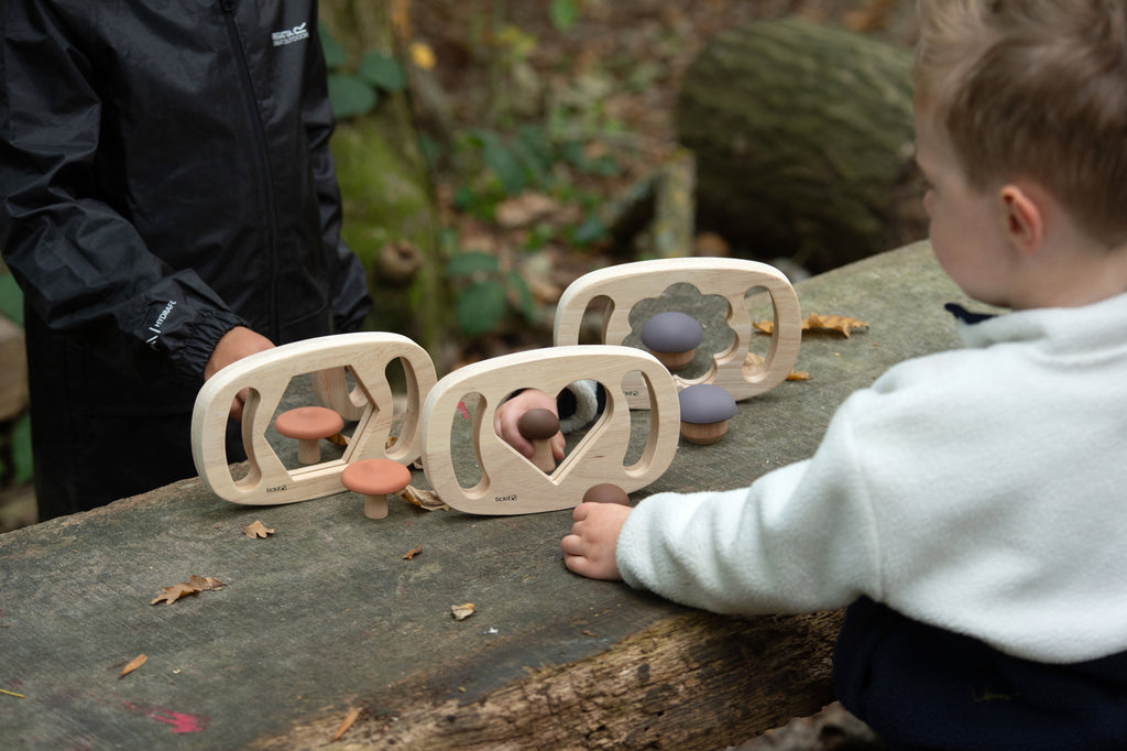 Wooden shape mirror toys in multiple frames with mirrors on outdoor play surface