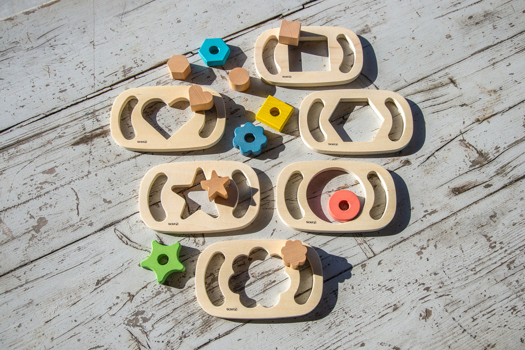 Wooden shape sorter set with curved trays and colorful wooden blocks laid out