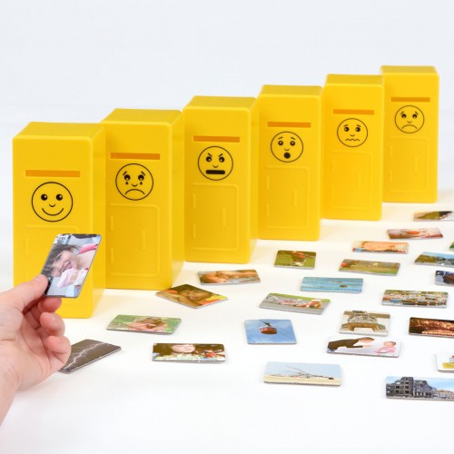 Emotions posting game with yellow emotion tiles and hands placing photo cards