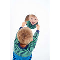 Face-shaped acrylic mirror held by hands, reflecting a child’s face