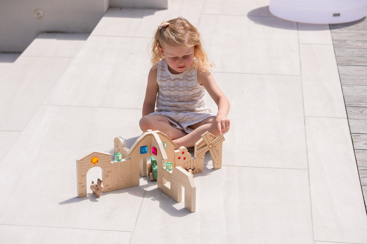 Wooden farm play dividers set with child playing among arched rooms, figures, and tools