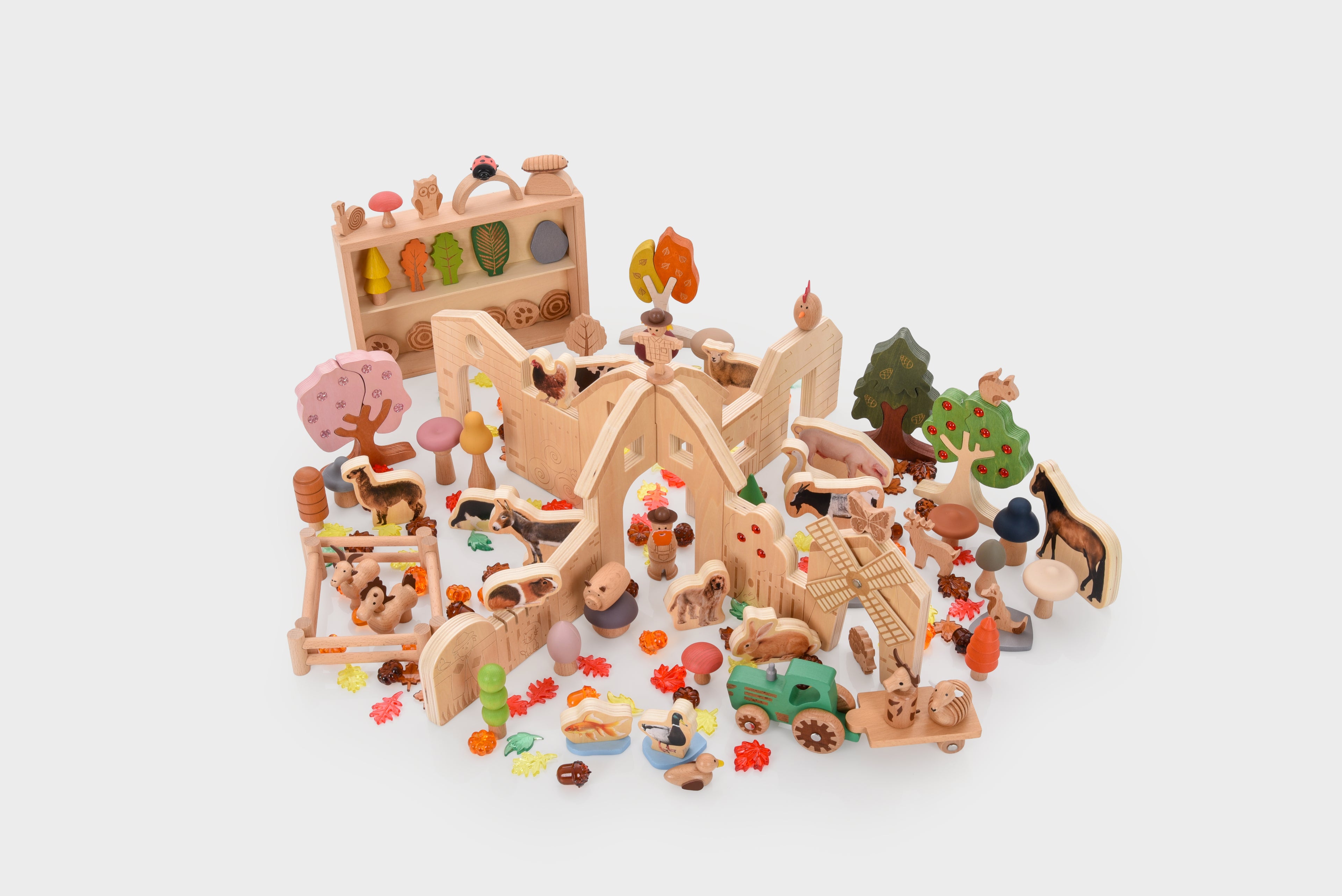 Wooden farm resource toy bundle with colorful animal figures and accessories spread out.