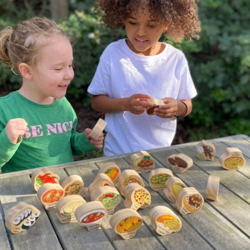 Mini world food play set with small printed bowls on a tabletop