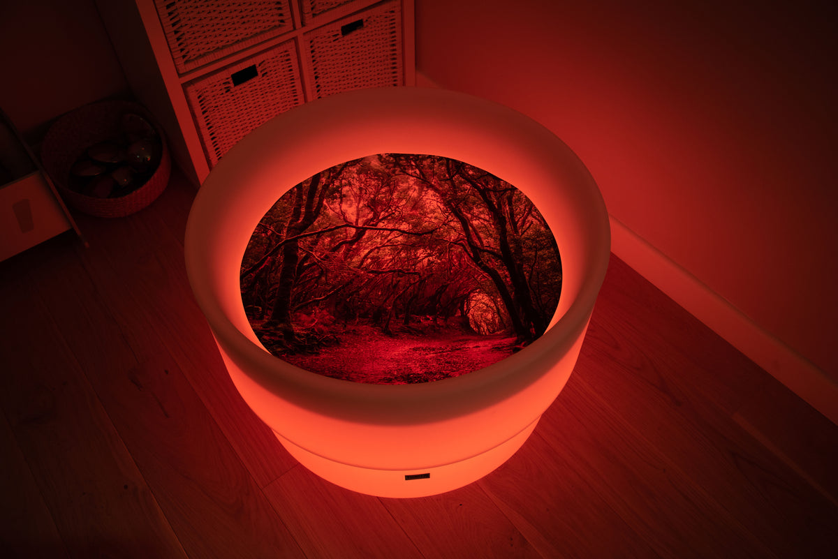 Round forest-themed play mat with glowing rim and forest path insert, red lighting