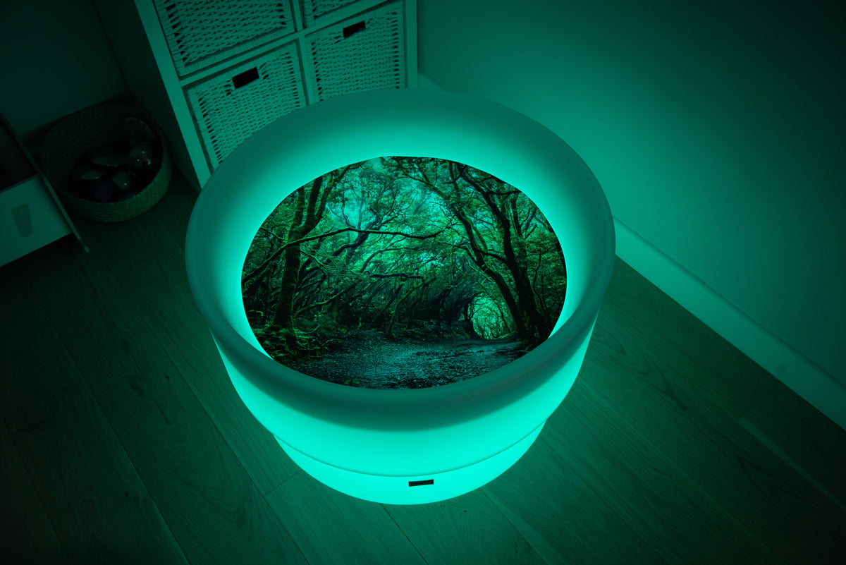 Round forest-themed play mat with glowing rim and forest path insert, green lighting