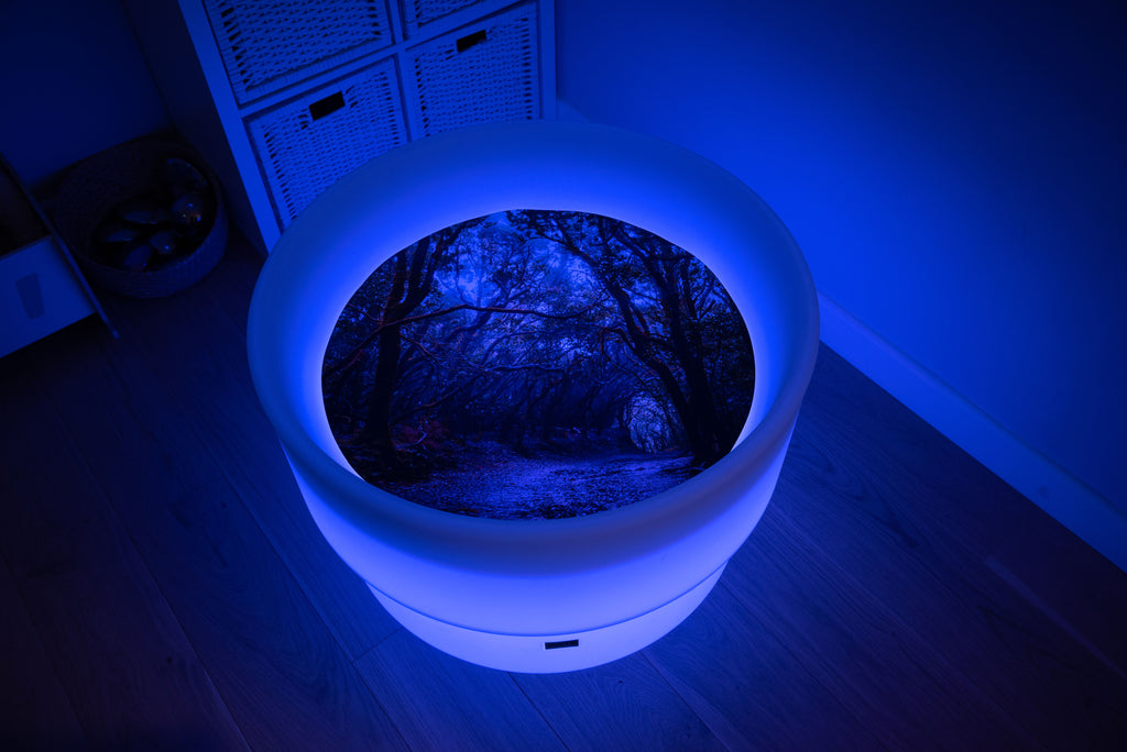 Round forest-themed play mat with glowing rim and forest path insert, blue lighting
