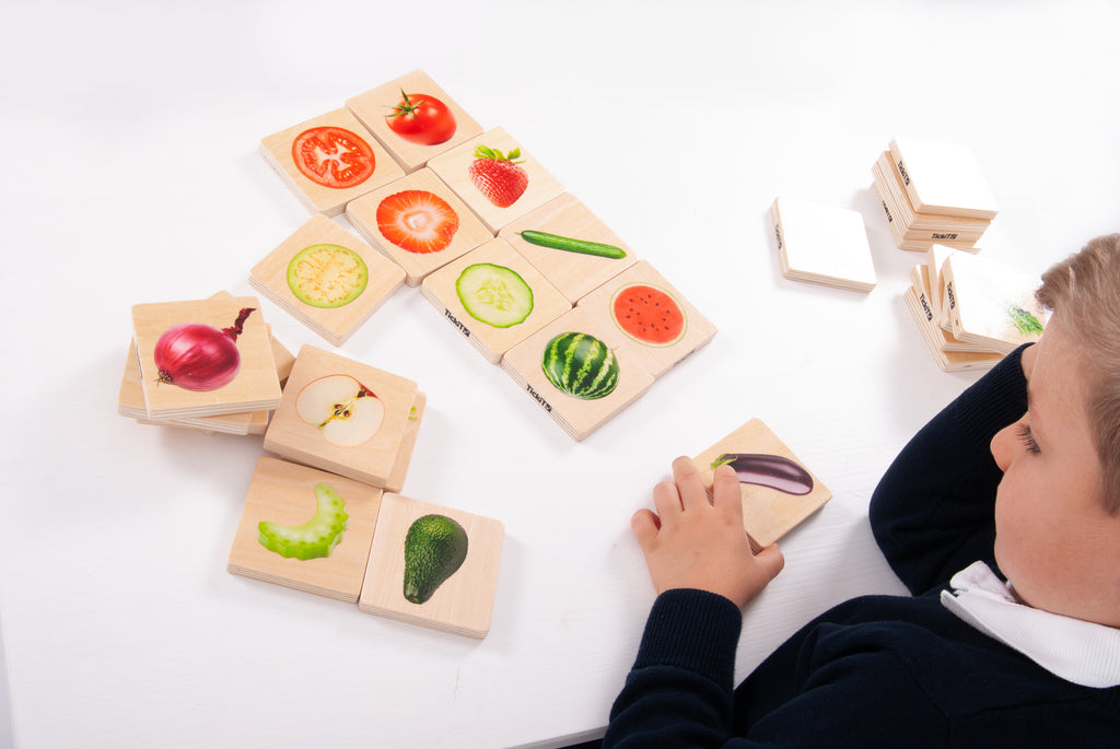 Fruit and vegetable picture cards with a child arranging matching tiles