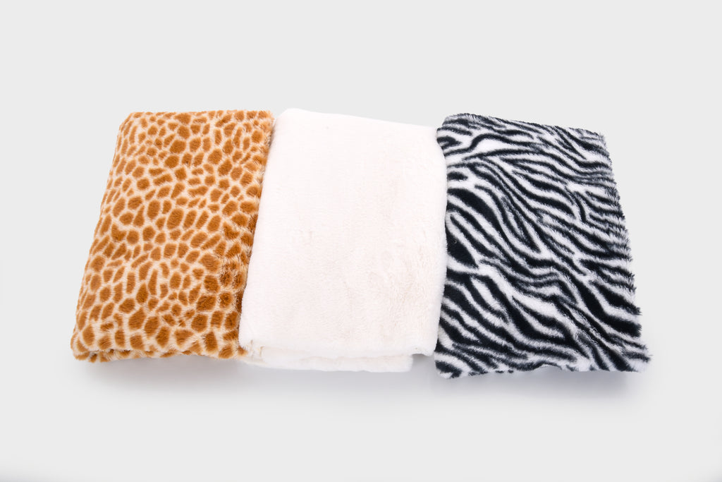 Three-color plush fabric bundle: orange giraffe spots, white solid, black zebra stripes