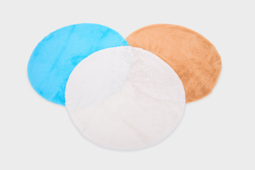 Three-layer round plush mat set in light blue, white, and tan