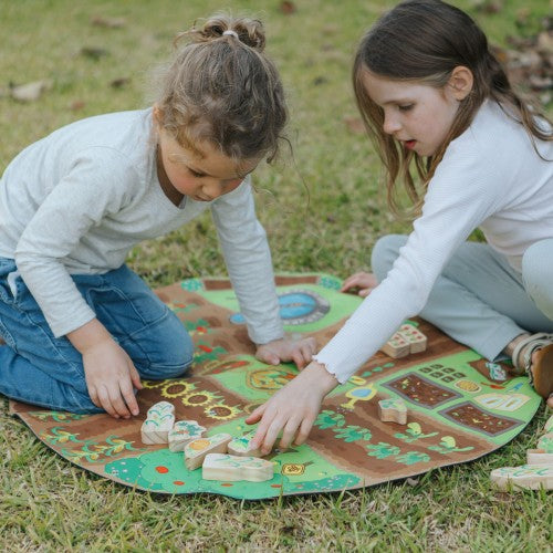 Garden-themed circular activity mat with colorful animal and plant graphics