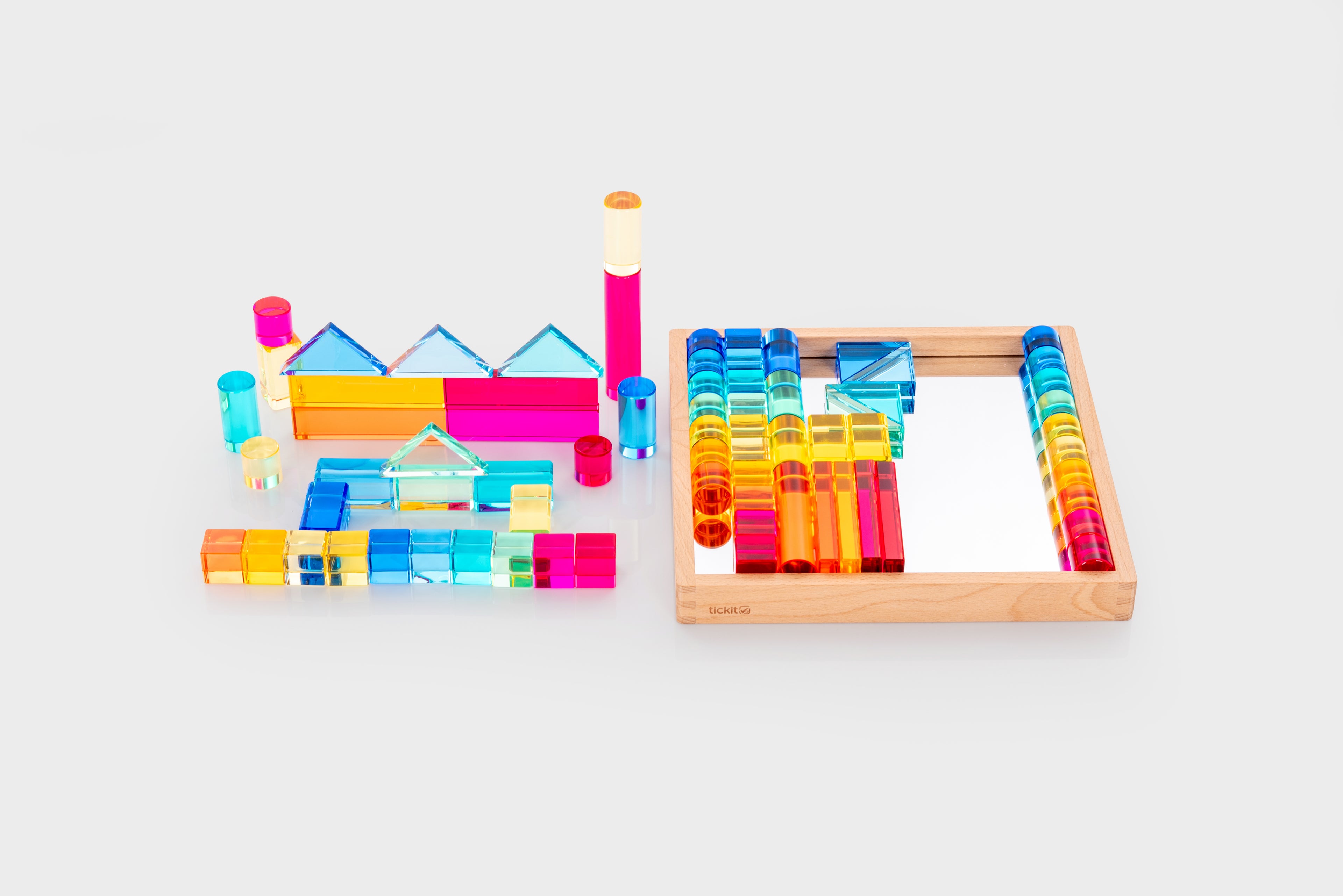 Wooden gem building shapes tray with colorful transparent tubes, bars, and blocks