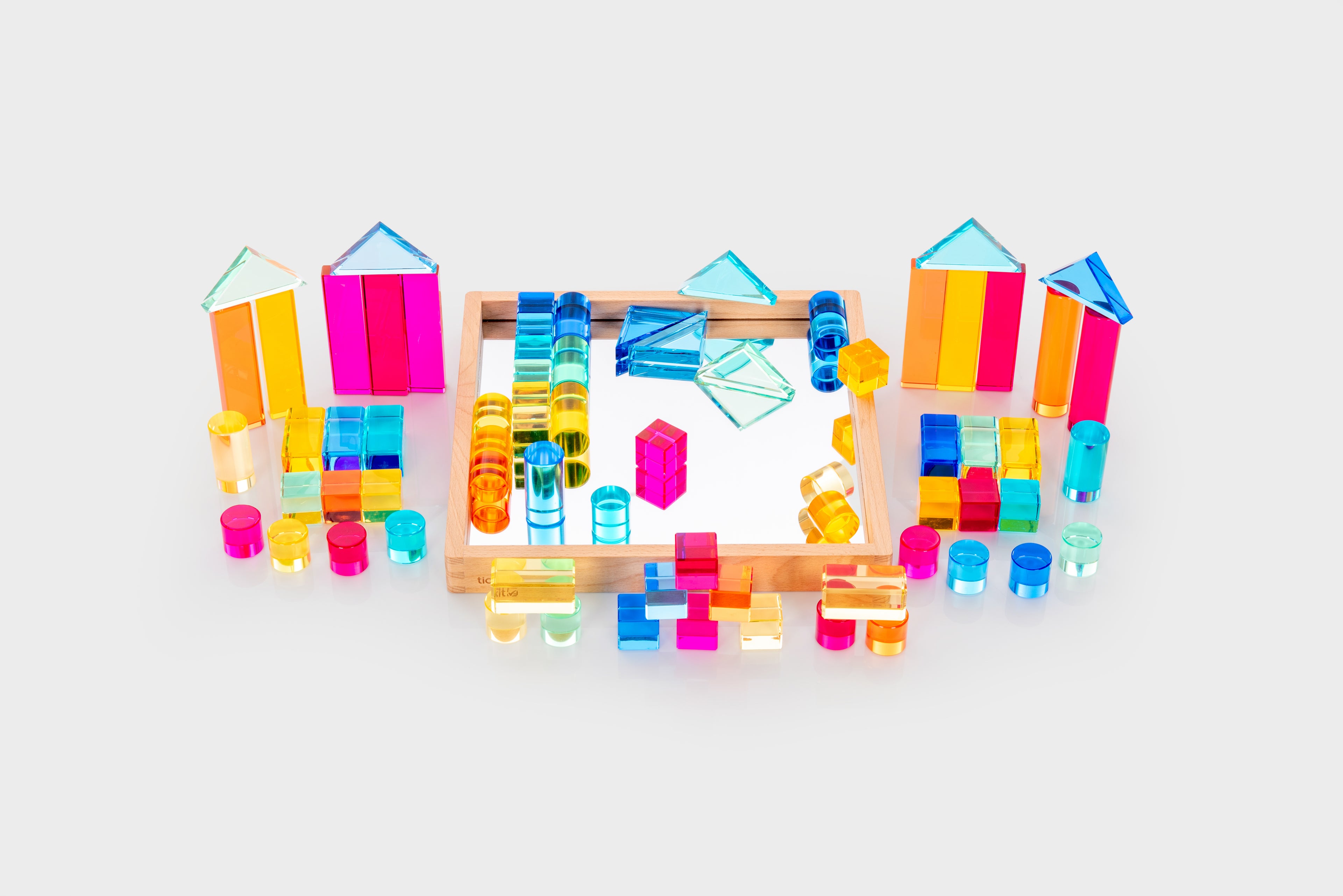 Gem building shapes tray with colorful transparent blocks, tubes, and small structure pieces