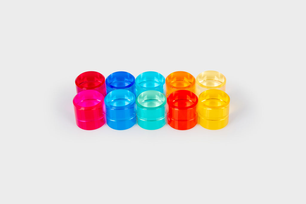 Colorful clear gem cylinders arranged in two rows: red, blue, teal, orange, and yellow.