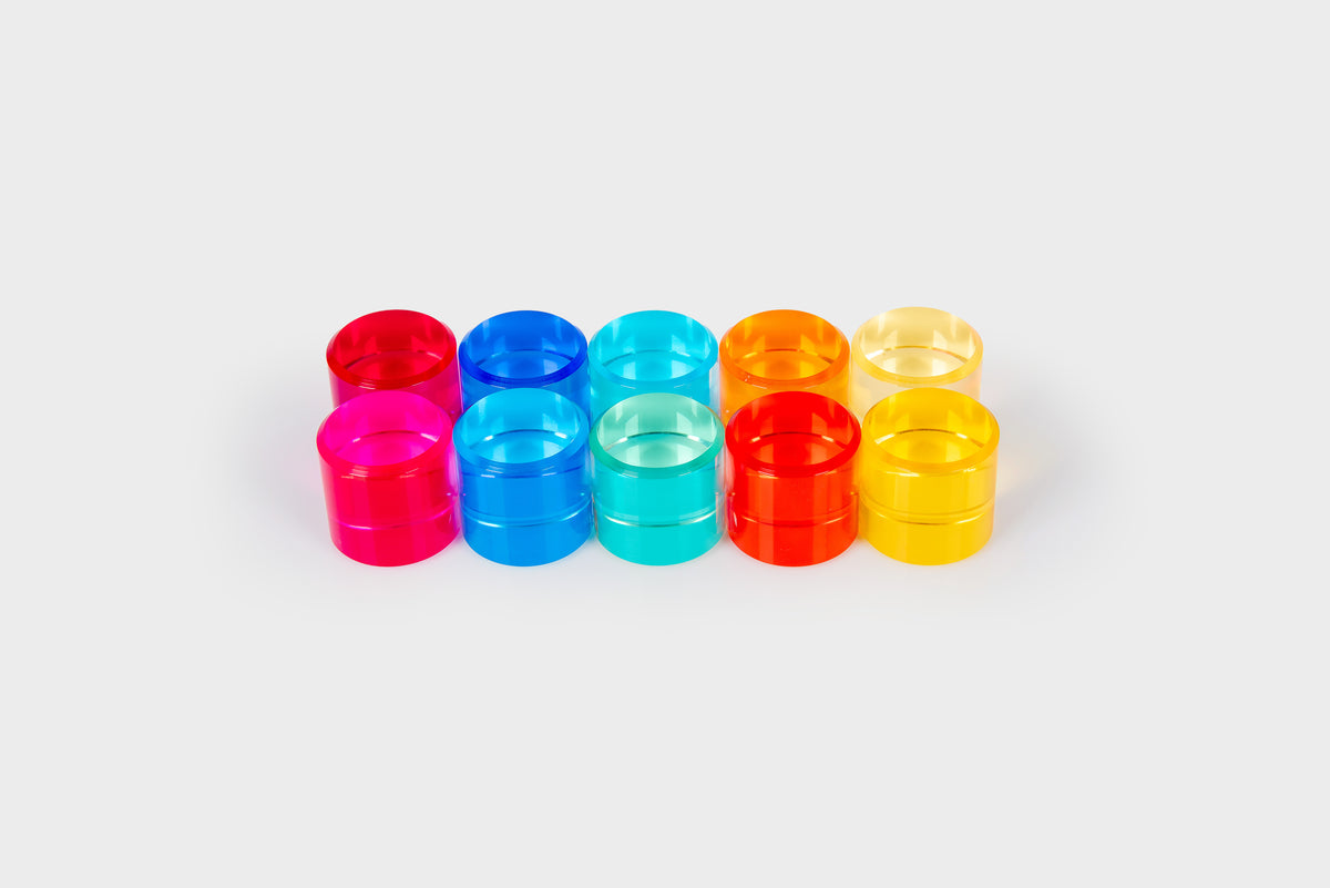 Colorful clear gem cylinders arranged in two rows: red, blue, teal, orange, and yellow.