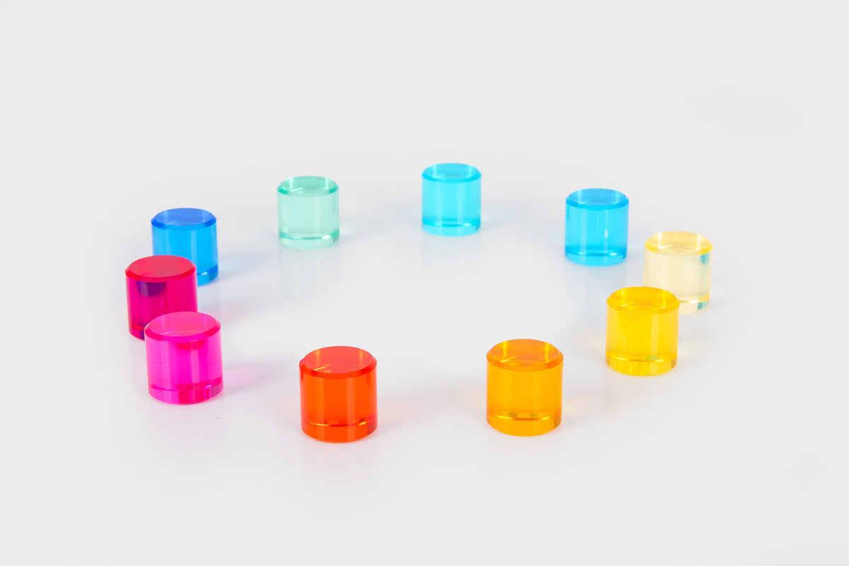 Clear gem cylinders in bright pink, blue, orange, and yellow, arranged in an arch.