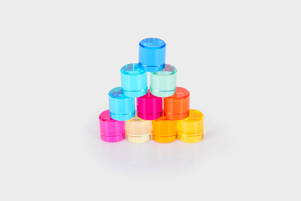 Stackable clear gem cylinders in blue, teal, pink, orange, and yellow.