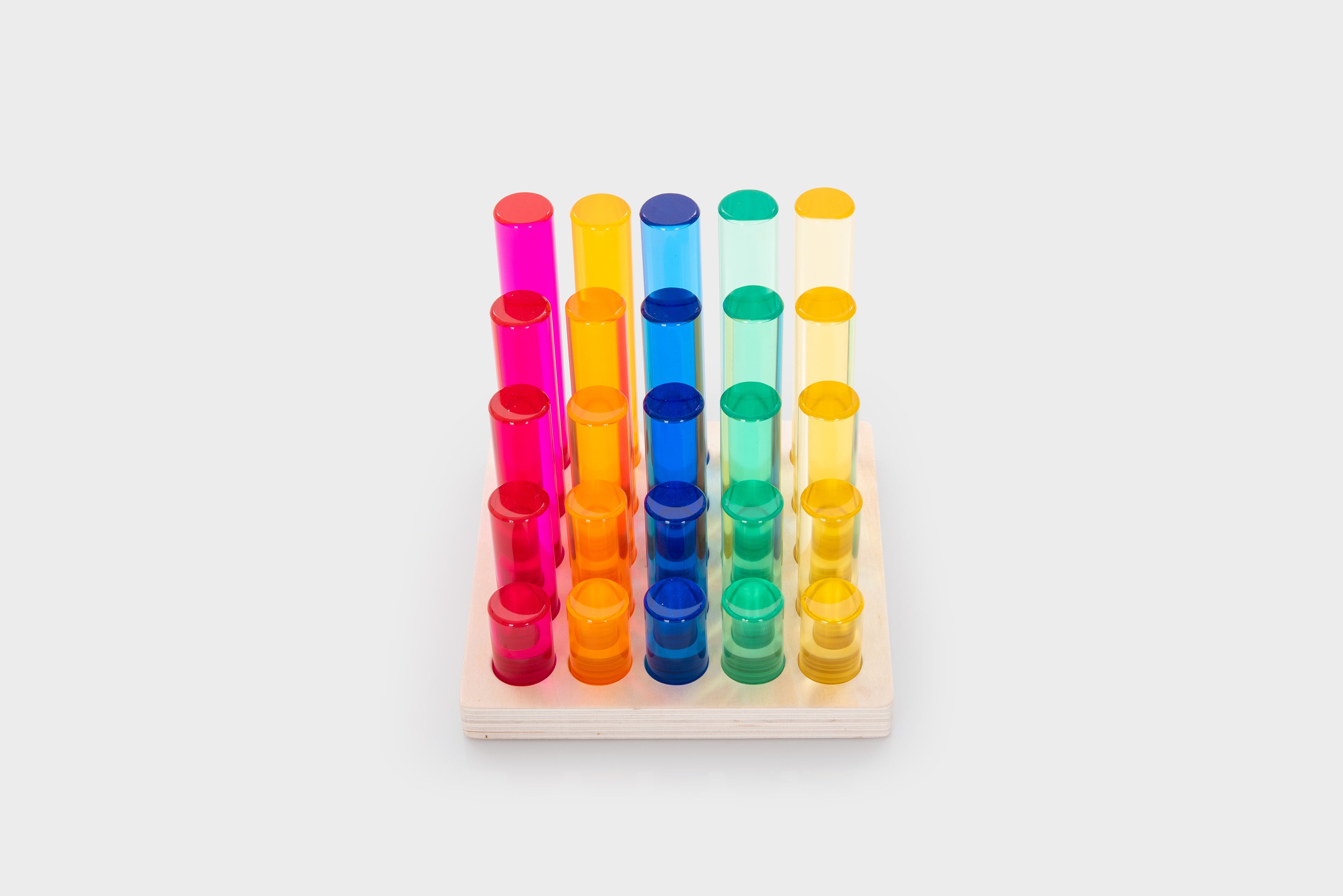 Gem column set: multicolor vertical tubes in a grid on a light wooden tray