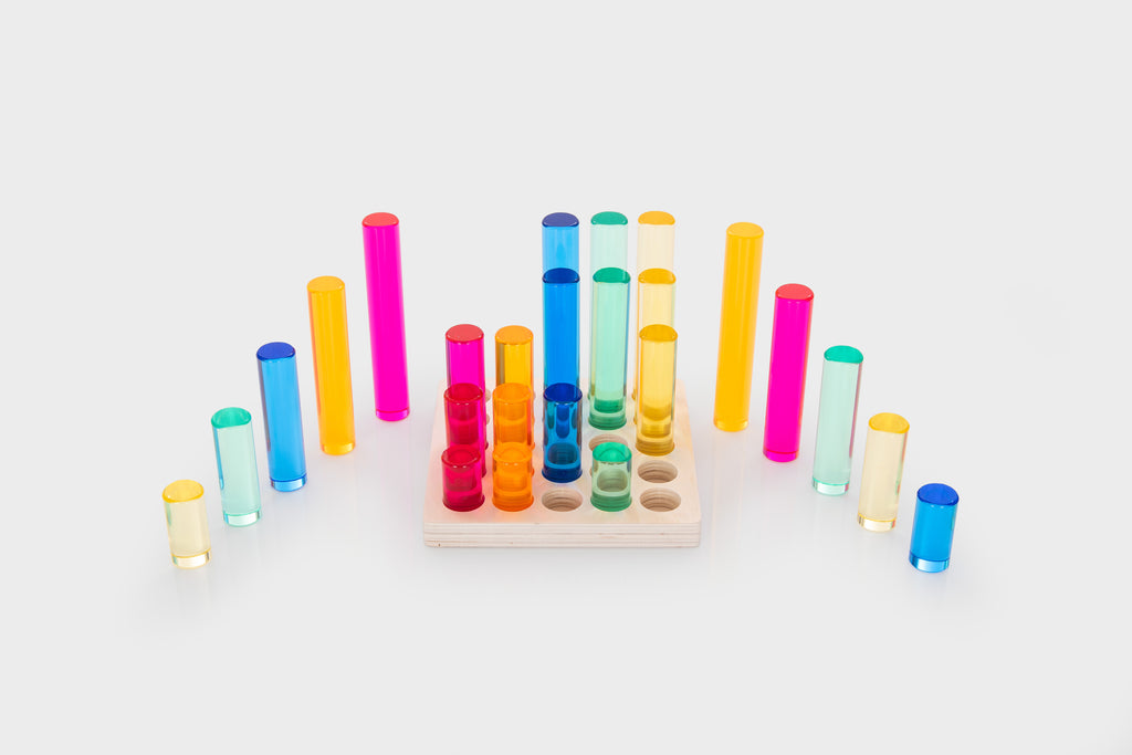 Gem column set with multicolor gem tubes arranged around a light wooden base tray
