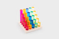 Gem column set with multicolor tubes, neatly arranged on a light wooden square tray