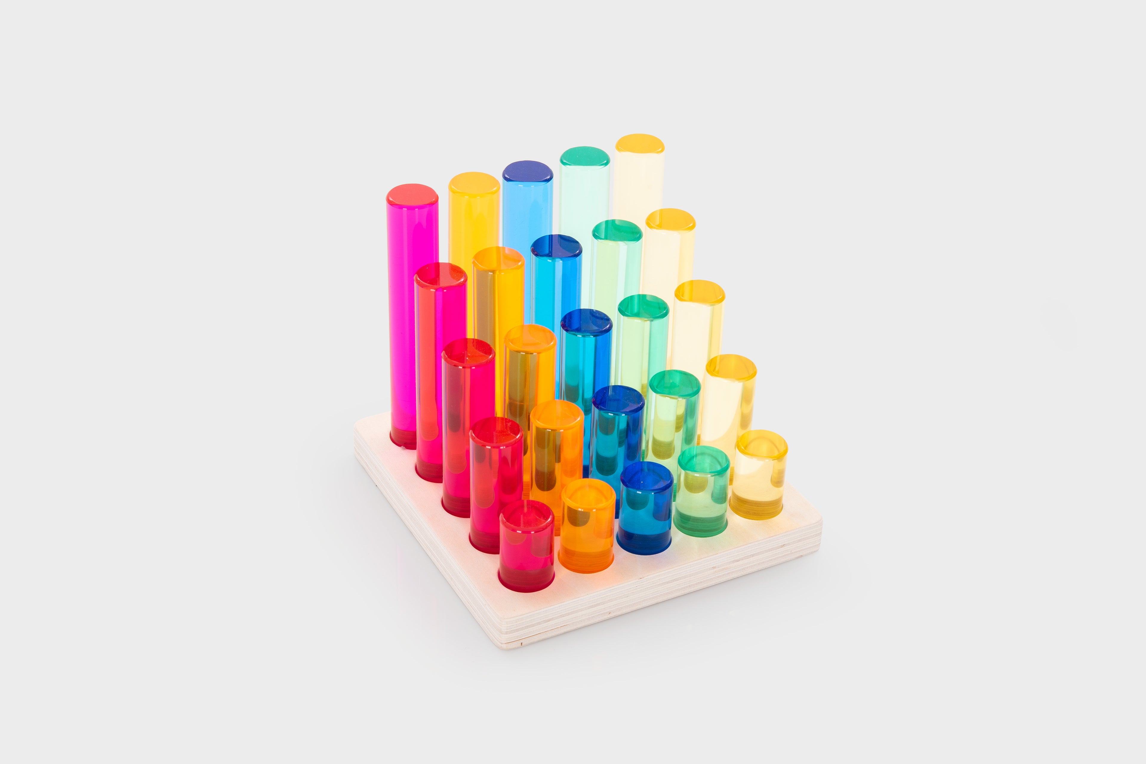 Gem column set with multicolor tubes, neatly arranged on a light wooden square tray