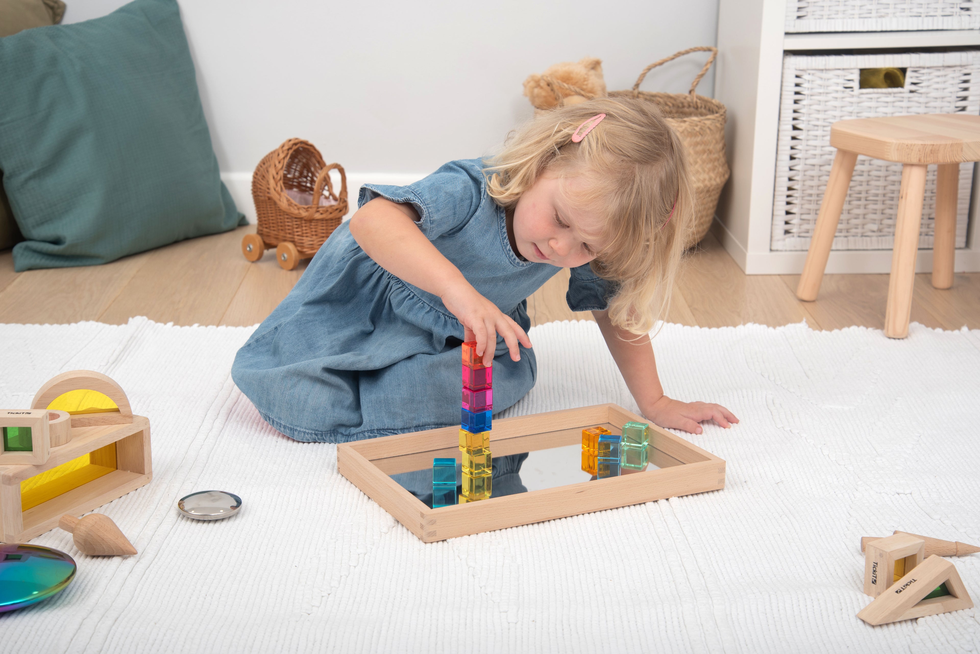 Translucent gem cube blocks stacked in a wooden frame board for play