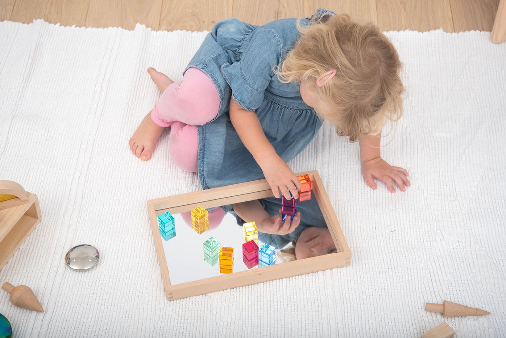 Translucent gem cube blocks arranged inside a wooden tray