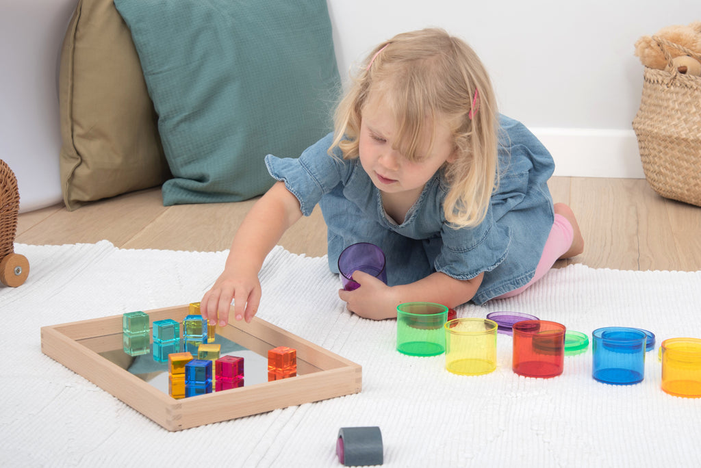 Colorful translucent gem cube blocks in a wooden tray for stacking and sorting
