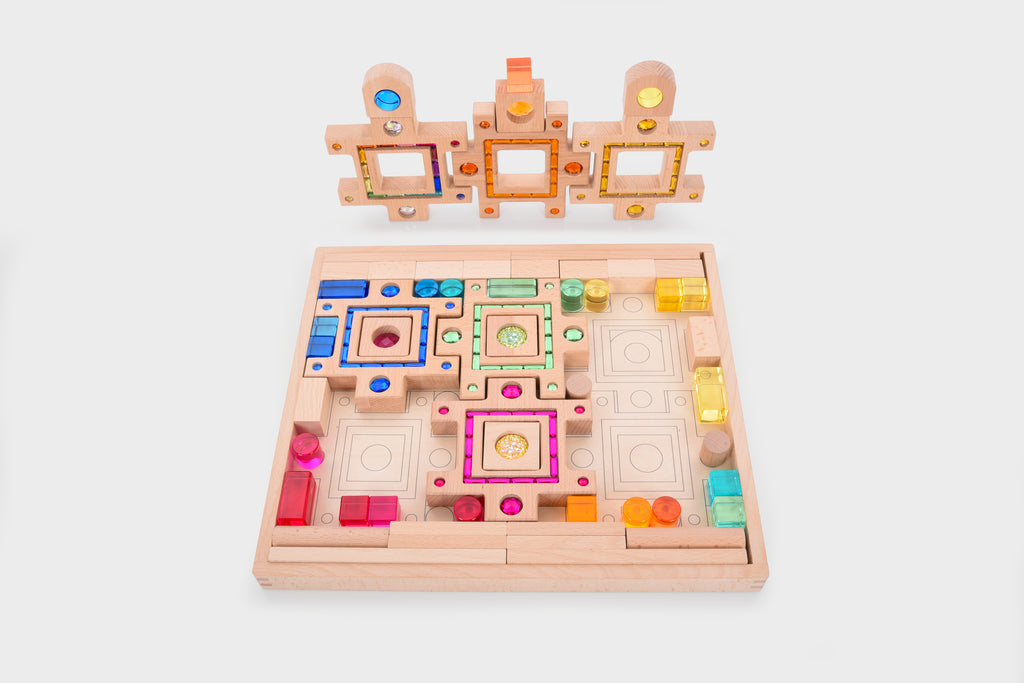Wooden gem puzzle board with colorful geometric openings and gem pieces