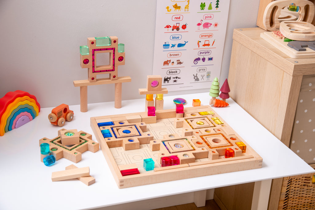Wooden gem puzzle set on table with multicolor block tiles and matching pieces