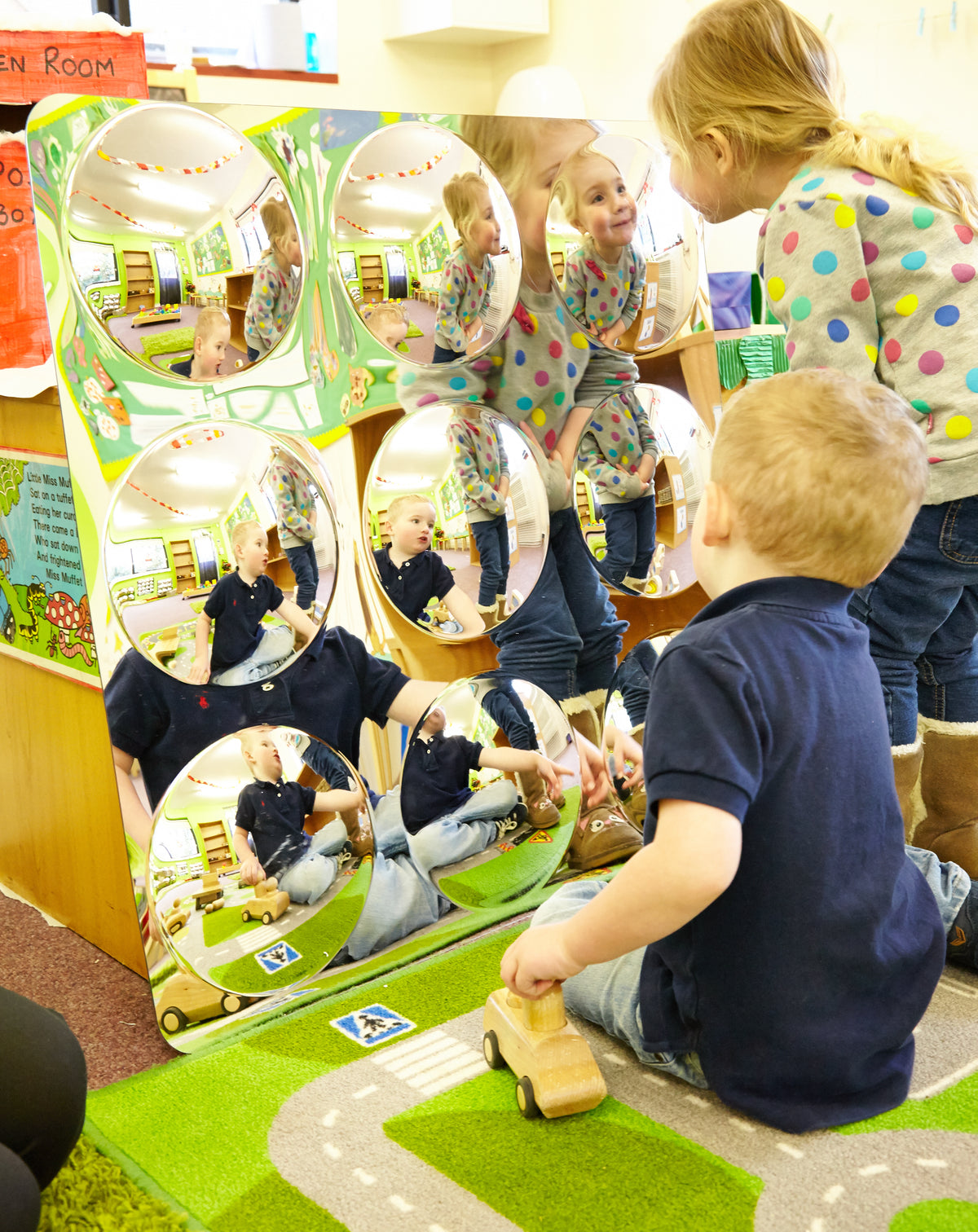 Acrylic 9-dome mirror panel with circular domes reflecting children inside a play area