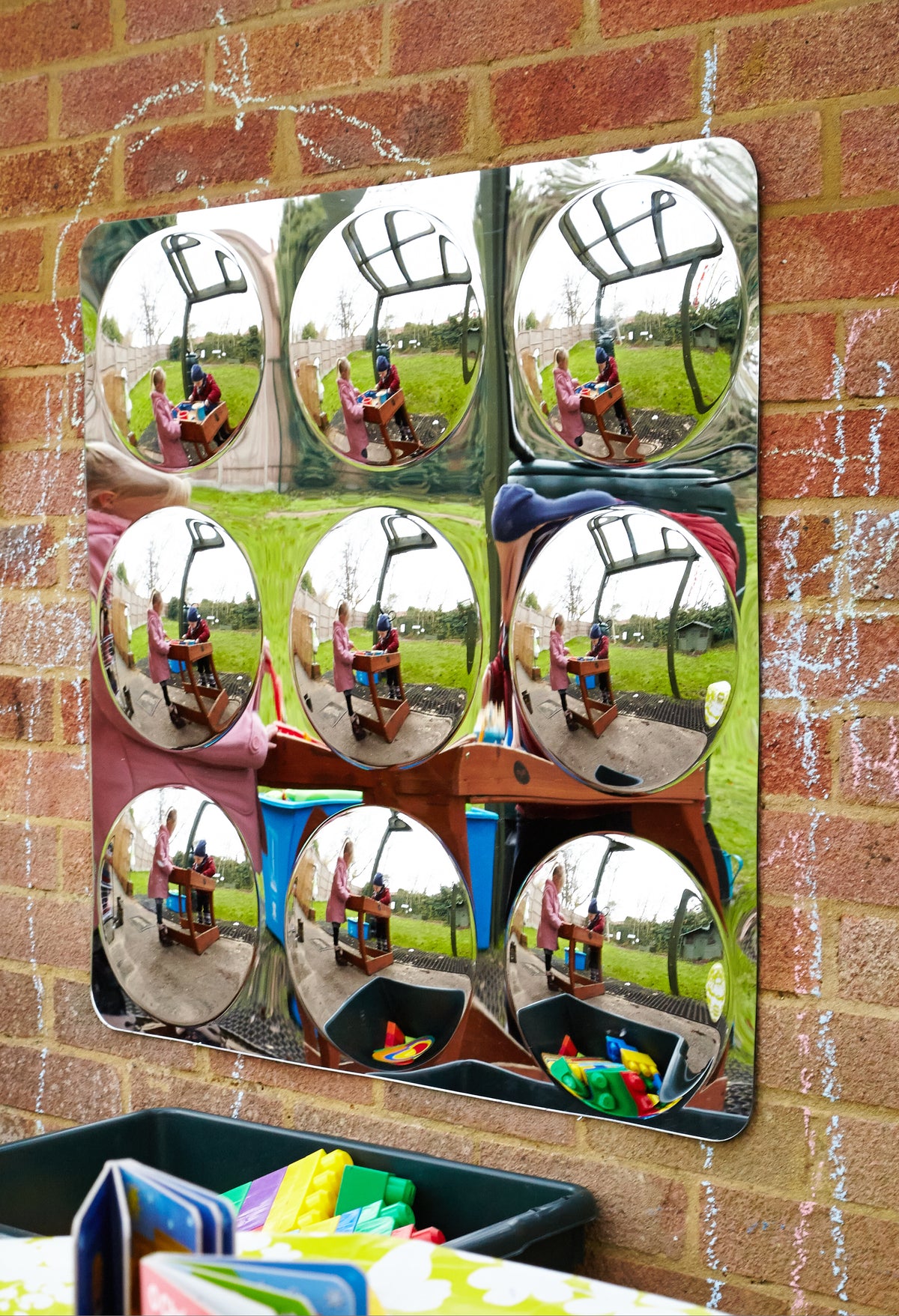 Acrylic 9-dome mirror panel on brick wall showing multiple dome reflections