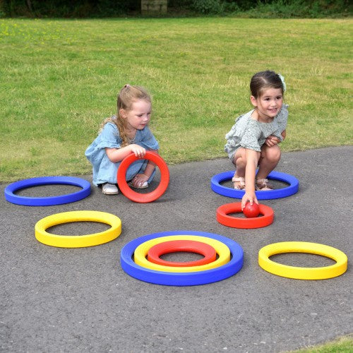 Giant activity ring set with large blue, red, and yellow rings for outdoor play