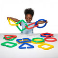 Giant linking shapes set with colorful foam interlocking pieces, held by a child