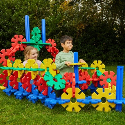 Giant interlocking plastic gears set with colorful bars and pegs, large outdoor play toy