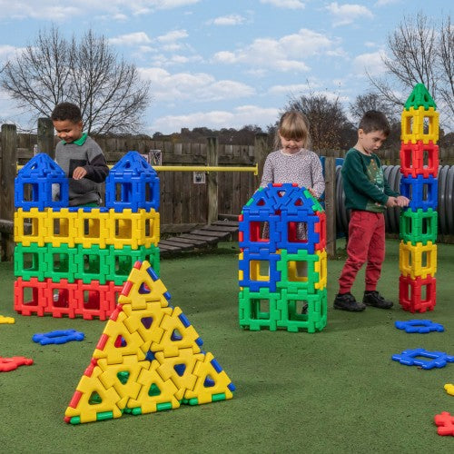 Colorful interlocking plastic construction pieces: tall towers, dome, and pyramid shapes