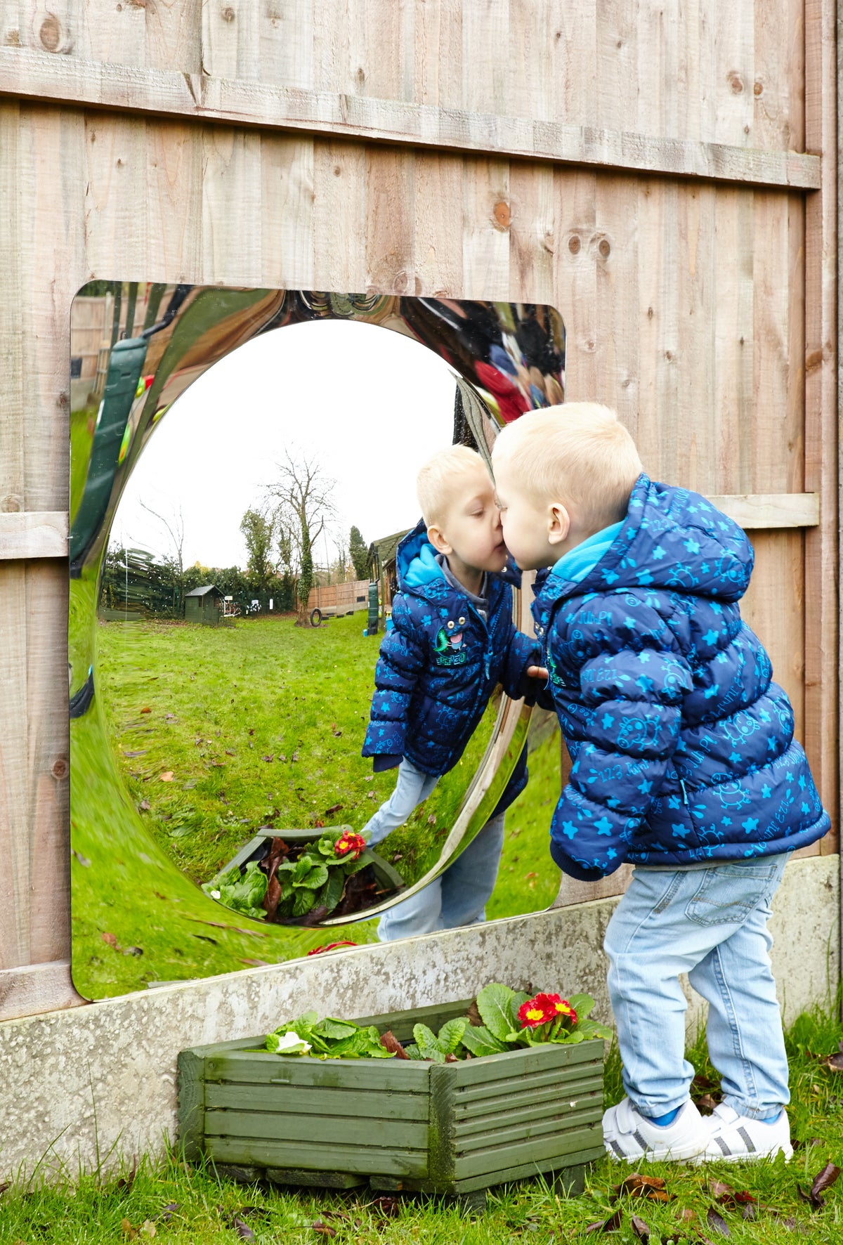 Single acrylic dome mirror panel set into wooden wall with curved reflective opening