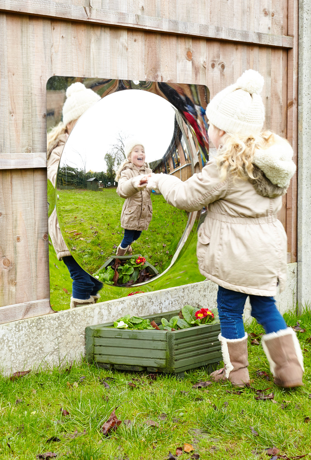 Acrylic dome mirror panel in wooden wall with rounded reflective opening for kids
