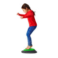Child standing on green and dark gray spring balance rocker toy