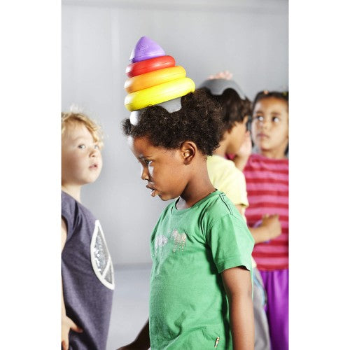 Clown hat balance toy on a child’s head: stacked purple yellow orange rings