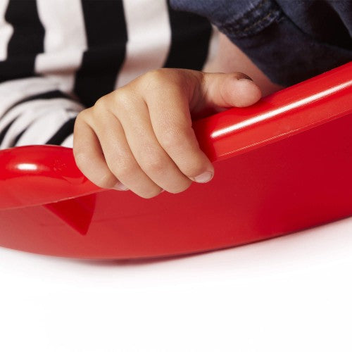 Red cone sit-in spinning toy with hand gripping the rim