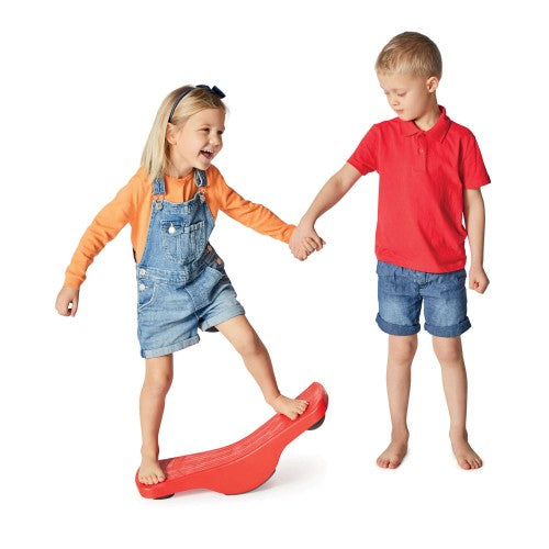 Red seesaw balance board being stepped on by two children