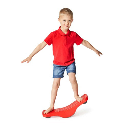 Red seesaw rocker balance board with child stepping on one end