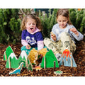 Children's dinosaur play scene with green mountains and printed dinosaur pieces