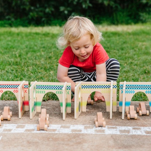 Wooden race track playset with arch supports and small cars, set for toddlers