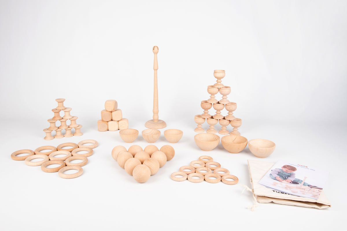 Wooden heuristic play starter set pieces: rings, balls, stacking towers, and bowls