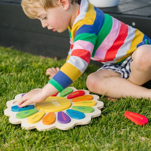 Colorful wooden shape activity puzzle with rounded pieces on grass