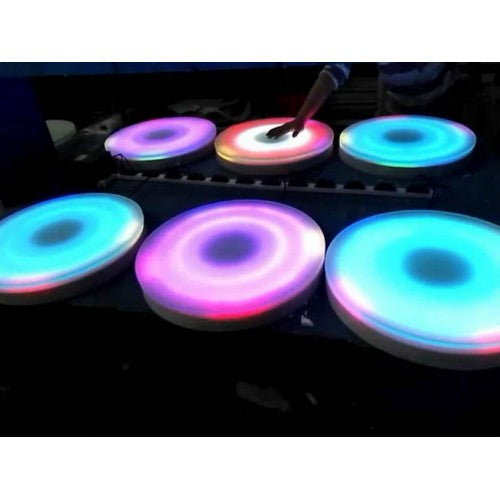 Set of glowing round floor tiles with multicolor LED rings