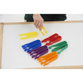 Colorful jumbo tweezers in six colors, fanned on a white board with a hand holding one