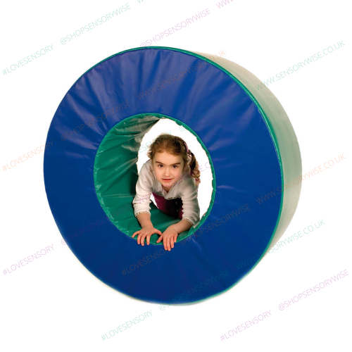 Blue and green fabric play wheel tunnel with child peeking through center opening