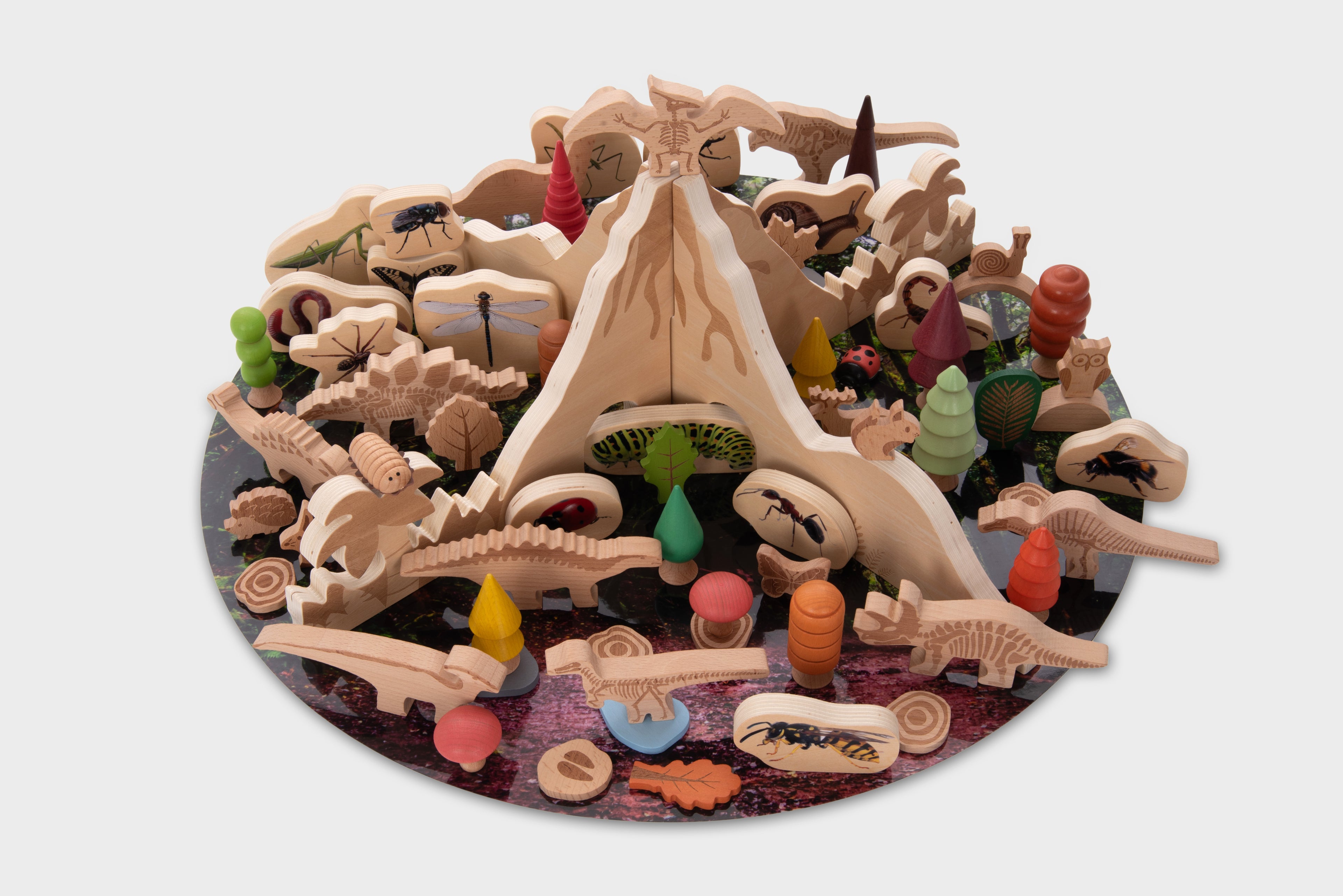 Assorted dinosaur toy pieces bundle with rocky terrain and small figures, on circular base